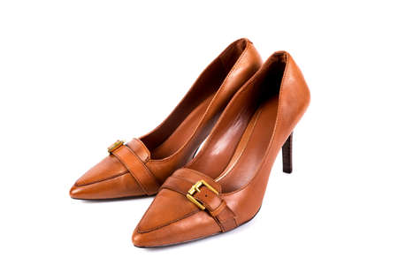 Brown women's high-heeled shoes on a white backgroundの写真素材