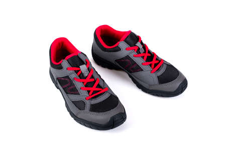 gray and pink children's sneakers on a white backgroundの写真素材