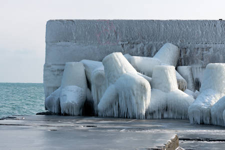 Concrete breakwater with snow and ice at Black sea costの写真素材