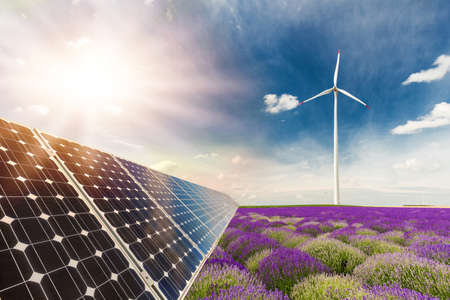 Photo collage of solar panels and wind turbins against the crops background - concept of sustainable resourcesの写真素材
