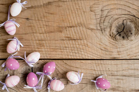Easter eggs over white wooden vintage table - top view, copy spaceの写真素材