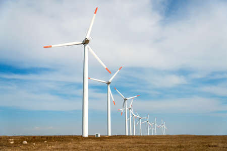 Wind turbines  against a blue sky generating electricity - concept of sustainable development