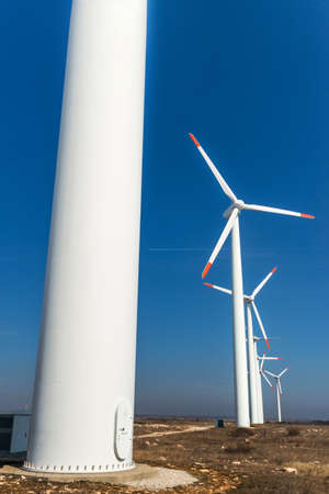 Wind turbines  against a blue sky generating electricity - concept of sustainable development