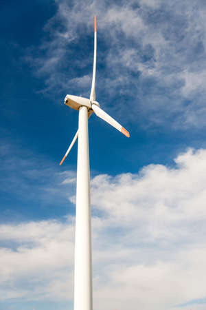 Wind turbines  against a blue sky generating electricity - concept of sustainable development