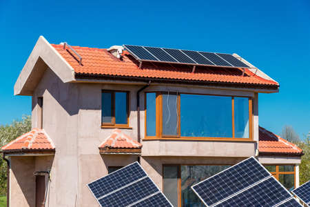 Solar panel on a red roof - alternative electricity sourceの写真素材