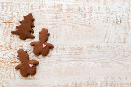 Christmas gingerbread cookies with different shapes over a white vintage wooden tableの写真素材