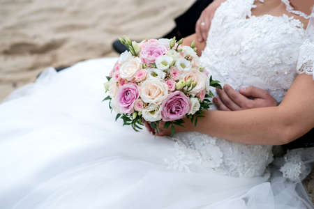 Bride and groom holding their hands - detail. Selective focus, copy spaceの写真素材