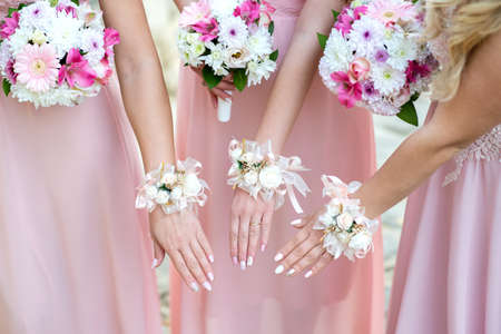 Glorious bridesmaids in pink dresses holding beautiful flowers - selective focusの写真素材