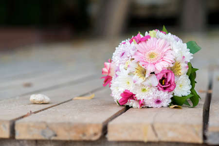 bridal bouquet on a wooden bench - selective focus, copy spaceの写真素材