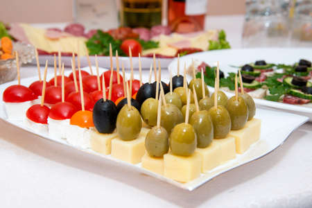 Close up of small canapes arranged on a plate over light background - selective focusの写真素材