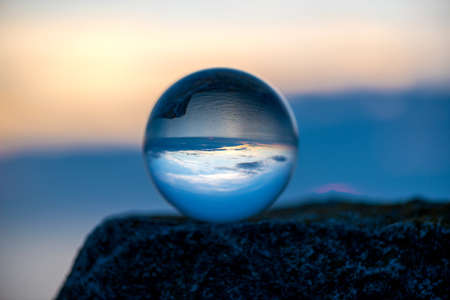 Upside down sunset landscape at Cape Kaliakra, Bulgaria, Eastern Europe - reflection in a lensball -...