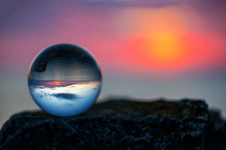 Upside down sunset landscape at Cape Kaliakra, Bulgaria, Eastern Europe - reflection in a lensball - selective focus, space for textの写真素材