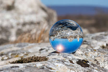 Upside down landscape of Pobiti Kamani, The Stone Forest Natural Reserve near Varna in Bulgaria, Eastern Europe - reflection in a lens ball - selective focus, space for textの写真素材