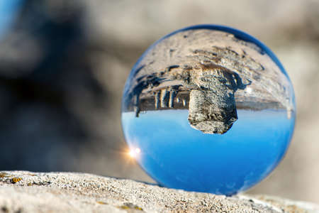 Upside down landscape of Pobiti Kamani, The Stone Forest Natural Reserve near Varna in Bulgaria, Eastern Europe - reflection in a lens ball - selective focus, space for textの写真素材