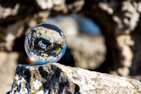Upside down landscape of Pobiti Kamani, The Stone Forest Natural Reserve near Varna in Bulgaria, Eastern Europe - reflection in a lens ball - selective focus, space for textの写真素材