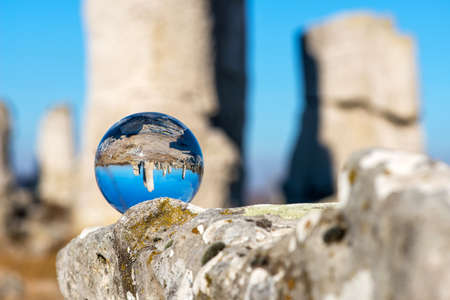 Upside down landscape of Pobiti Kamani, The Stone Forest Natural Reserve near Varna in Bulgaria, Eastern Europe - reflection in a lens ball - selective focus, space for textの写真素材