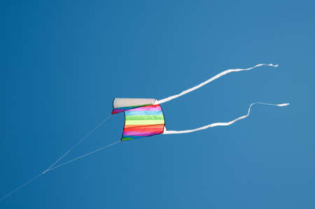 Colorful kites flying in blue sky
