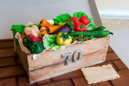 Anniversary cake shaped like a crate with vegetables - top viewの写真素材