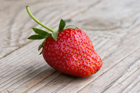 Close-up of an organic strawberry on a wooden backgroundの写真素材