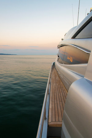 Beautiful sea view from the left board of a luxury yacht at sunset / sunrise - vertical orientationの写真素材