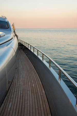 Beautiful sea view from the starboard side of a luxury yacht at sunset / sunrise - vertical orientationの写真素材