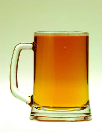 Glass with beer close-up, isolated on white backgroundの写真素材