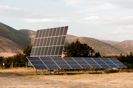 Solar panels at the foot of the mountainの写真素材