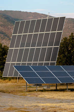Solar panels at the foot of the mountainの写真素材