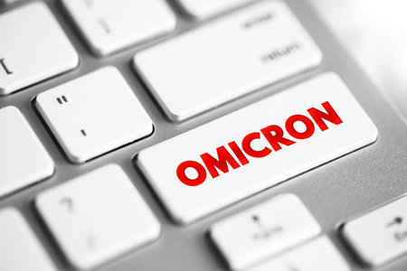 Omicron is the name given to a variant of the SARS-CoV-2 virus, which causes COVID-19, text concept button on keyboardの写真素材