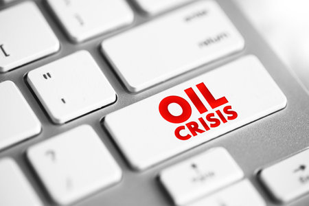 Oil Crisis - a significant and often sudden disruption in the supply of oil, leading to increased prices and economic turmoil, text concept button on keyboardの写真素材