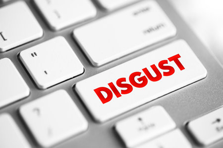 Disgust - a feeling of revulsion or strong disapproval aroused by something unpleasant or offensive, text concept button on keyboardの写真素材