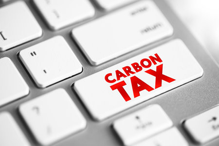 Carbon Tax is a tax levied on the carbon emissions required to produce goods and services, text concept button on keyboardの写真素材