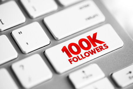 100K Followers - reaching 100,000 followers on a social media platform or other online platform, text concept button on keyboardの写真素材