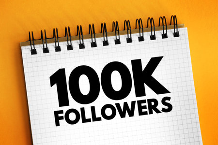 100K Followers - reaching 100,000 followers on a social media platform or other online platform, text concept on notepadの写真素材