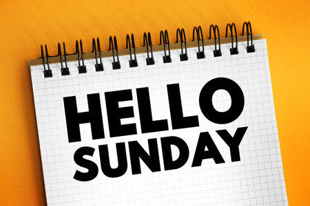 Hello Sunday - is a casual, friendly greeting used to welcome the day of Sunday, text concept on notepadの写真素材