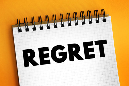Regret - feel sad, repentant, or disappointed over something that one has done or failed to do, text concept on notepadの写真素材