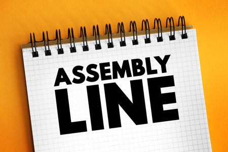Assembly Line is a production process that breaks the manufacture of a good into steps, text concept on notepadの写真素材