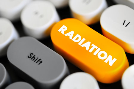 Radiation is energy that comes from a source and travels through space at the speed of light, text concept button on keyboardの写真素材