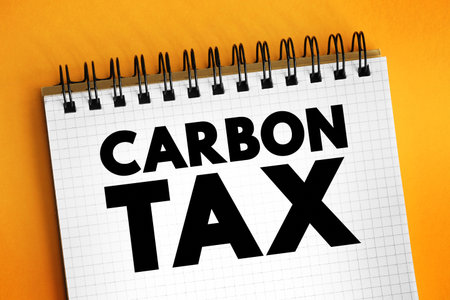Carbon Tax is a tax levied on the carbon emissions required to produce goods and services, text concept on notepadの写真素材