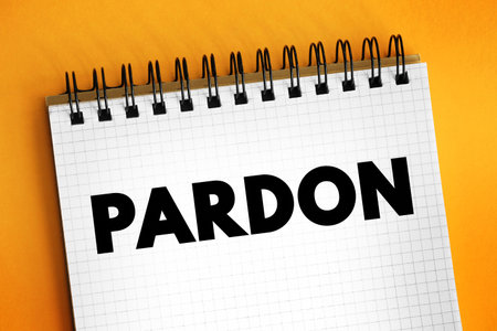 Pardon - the action of forgiving or being forgiven for an error or offence, text concept on notepadの写真素材