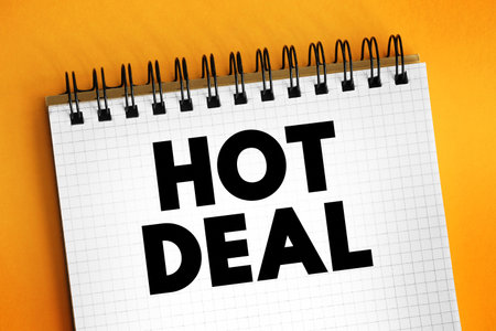 Hot Deal - a special offer or promotion that is particularly attractive due to its significant discount or favorable terms, text concept on notepadの写真素材