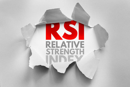 RSI acronym for Relative Strength Index revealed through torn paper. Financial indicator concept used in technical analysis for stock trading, overbought/oversold signals, and market momentumの写真素材
