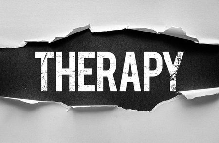 Grungy image with the word "THERAPY" boldly displayed under torn paper edges. Ideal for mental health, physical therapy, counseling, or wellness-related editorial useの写真素材