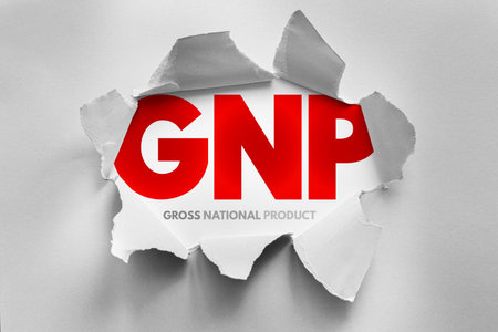 GNP acronym for "Gross National Product" displayed behind torn paper. Economic concept visual related to macroeconomics, national income, financial data, and international economic performanceの写真素材