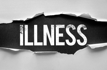 Word "ILLNESS" revealed behind torn white paper. Conceptual image illustrating sickness, healthcare challenges, or medical issues. Black grunge text under ripped surfaceの写真素材