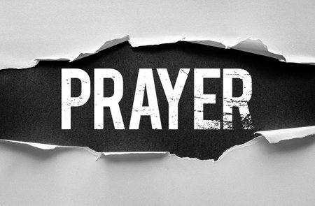 The word "PRAYER" in bold, distressed font is revealed through torn paper. A symbolic visual expressing faith, spirituality, hope, and inner reflection in a dramatic artistic conceptの写真素材