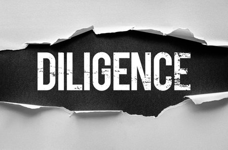 DILIGENCE word revealed through torn paper with bold distressed text. Concept symbolizing hard work, effort, consistency, patience, commitment, responsibility, and professional integrityの写真素材
