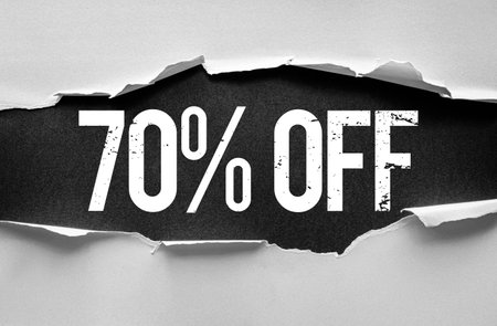 Bold distressed "70% OFF" text revealed through torn paper layers. Eye-catching discount banner or promotion graphic concept perfect for advertising, marketing, sales, or retail campaignsの写真素材