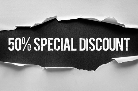 Bold â50% Special Discountâ message in distressed font revealed through torn paper background. Perfect for promotions, advertising banners, marketing materials, and seasonal sales campaignsの写真素材