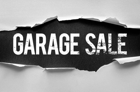 Garage Sale text displayed on a ripped paper background with bold, distressed font. Ideal for yard sale announcements, secondhand events, and promotional marketing or flyer design templatesの写真素材